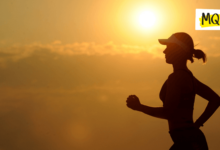 A runner is silhouetted against a sunset backdrop