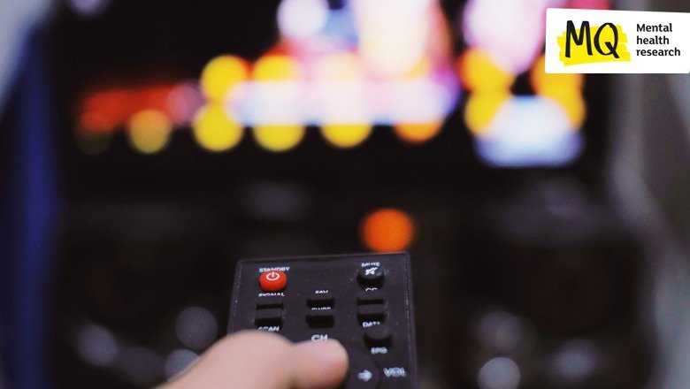 A TV remote control is pointed at a television set