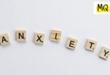 On a white background, scrabble tiles spell out the word 'anxiety' in a slight curve